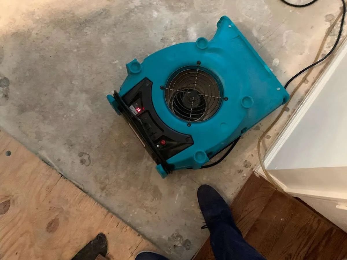 Air mover drying subfloor during Commercial Water Damage Restoration in Ocean City